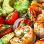 Avocado guacamole salad with chili shrimp by Chef Marrakech — fresh Moroccan-inspired starter served with lime, coriander, and cherry tomatoes.